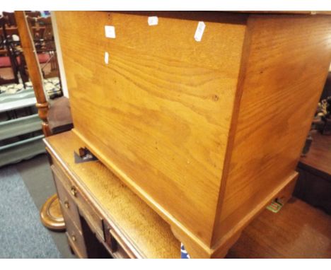 A light oak blanket chest raised on bracket feet