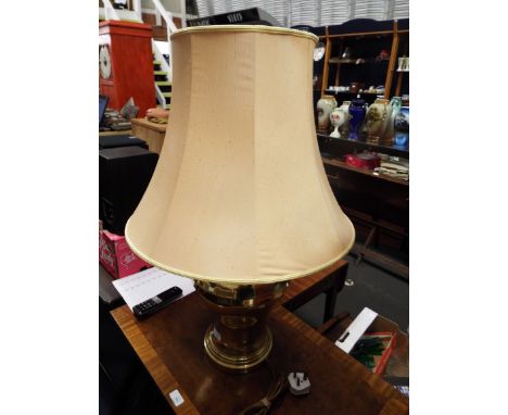 A large brass table lamp and shade