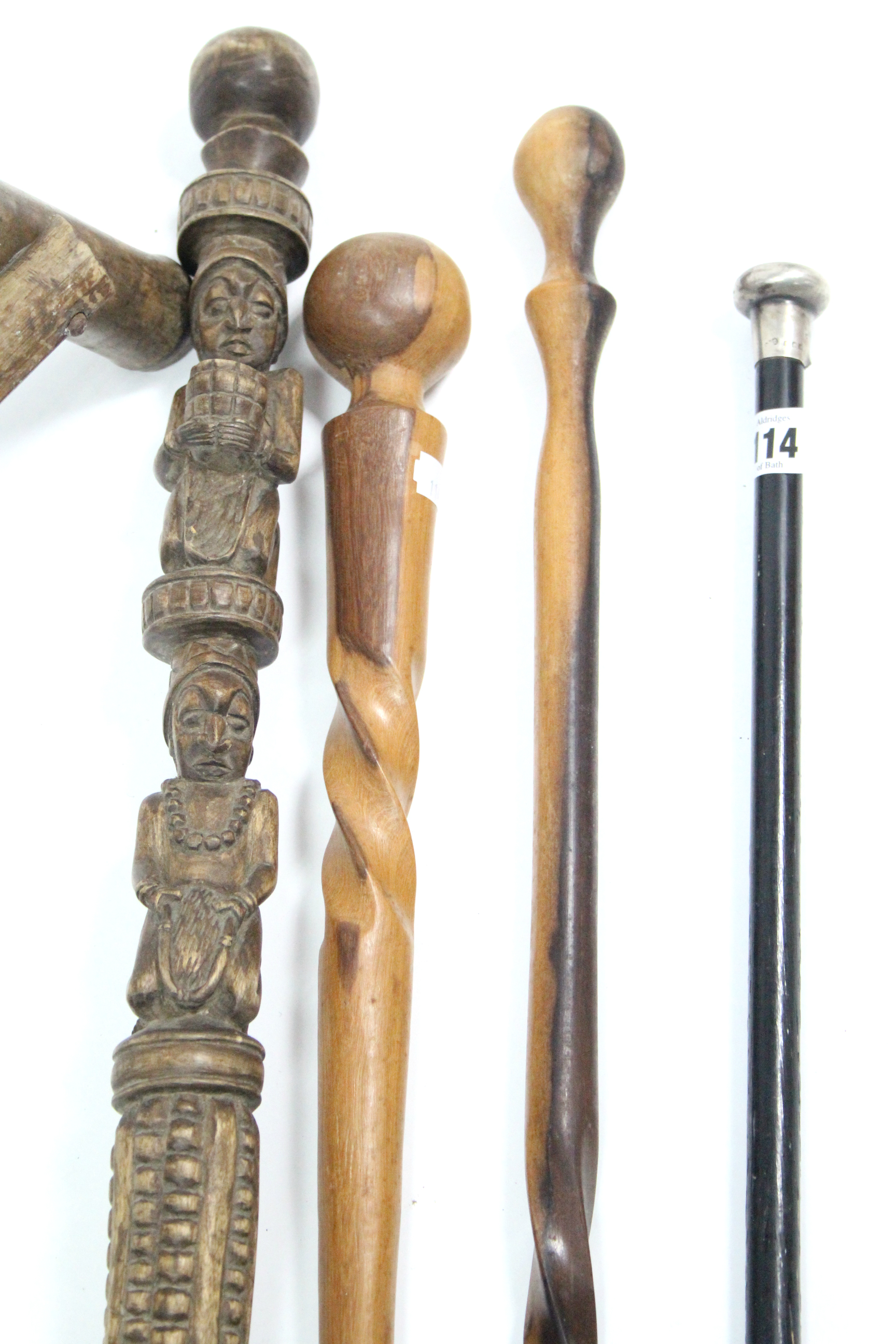 An ebonised gent’s walking cane with silver handle; together with three