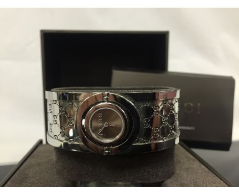 GUCCI DESIGNER BANGLE WATCH WITH ROTATING MOVEMENT THE WATCH IS COMPLETE WITH BOX, PAPERS AND RECEIPT FOR £875 R.R.P. 2007  