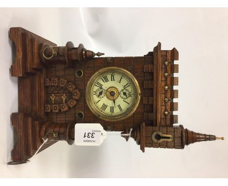 VICTORIAN NOVELTY MANTEL CLOCK IN AN OAK CASE DEPICTING A CASTLE WITH BATTLEMENTS AND TURRETS. BASIC MOVEMENT WITH AN ALARM F