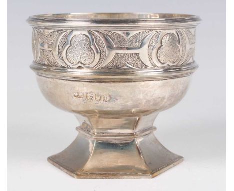 An Edwardian silver bowl in the form of a font, decorated with a Celtic style band, raised on a hexagonal flared foot, London