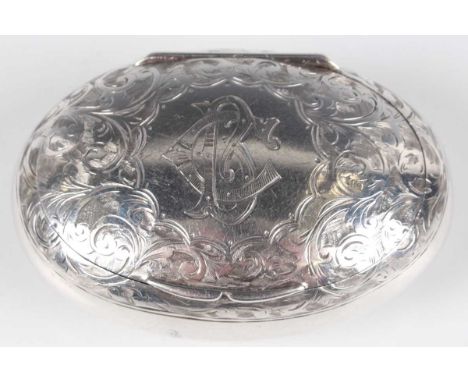 A late Victorian silver oval snuff box, the hinged lid monogram engraved, framed by foliate scrolls, Birmingham 1899 by Thoma