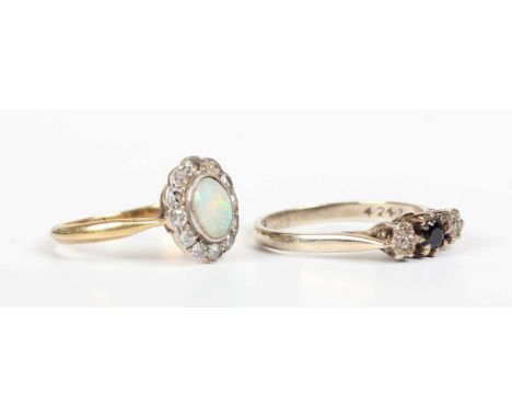 A gold, opal and diamond oval cluster ring, collet set with the oval opal to the centre, detailed ‘18ct’, weight 1.9g, ring s
