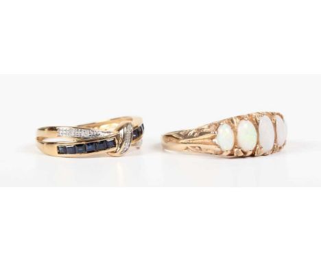 A 9ct gold and opal five stone ring, claw set with a row of graduated oval opals, the mount with scroll decorated sides, Birm