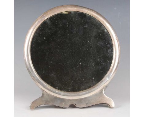 An Edwardian silver mounted dressing table mirror of circular form on bracket feet, London 1906 by William Comyns &amp; Sons,