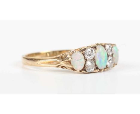 A gold, opal and diamond ring, mounted with three oval opals alternating with two pairs of old cut diamonds, the mount decora