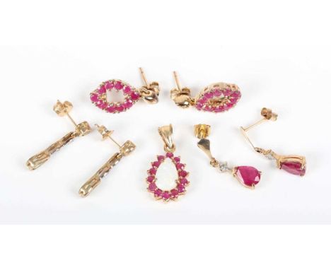 A 9ct gold, opal and ruby pendant, claw set with the pear shaped opal within a surround of circular cut rubies, length 2.2cm,