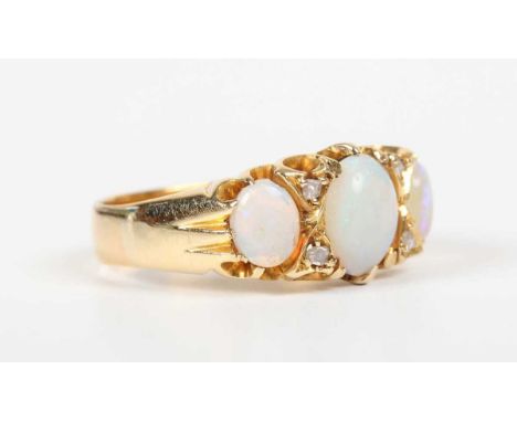 A gold, opal and diamond ring, mounted with oval opals alternating with two pairs of diamonds, weight 4.4g, ring size approx 