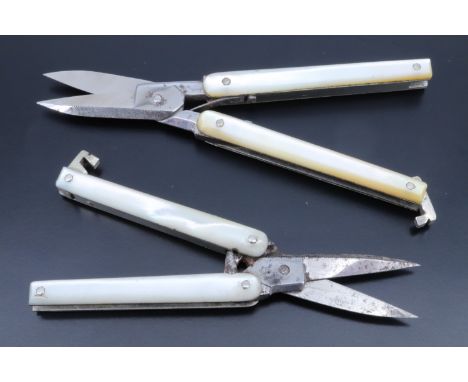 Two sets of Victorian folding scissors, having mother-of-pearl grips scales