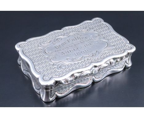 A Victorian silver pocket snuff box, of cusped form, engine turned and scroll-moulded, its lid bearing the engraved dedicatio