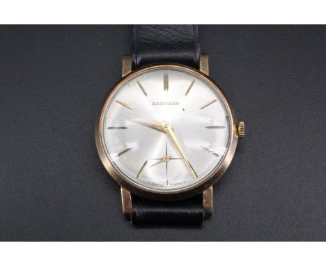 A 1960s Garrard 9 ct gold wristwatch, having a manual wind movement and circular radially-brushed silver face with gilt incis