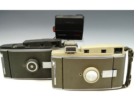 A Polaroid 800 land camera together with a Polaroid 110 A land camera and another Polaroid camera