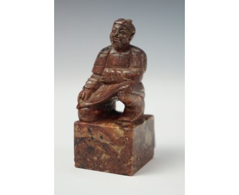 A Chinese soapstone seal in the form of a Xian warrior, 9 cm