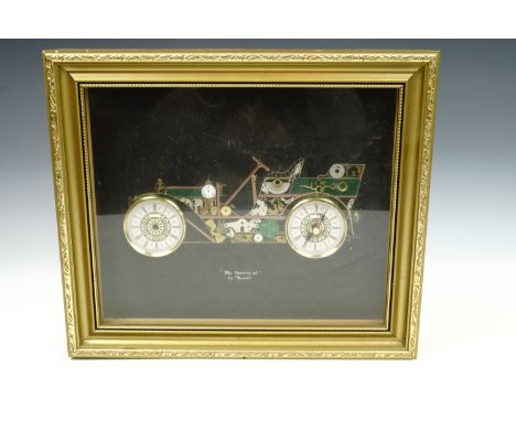 A 1970s kitsch Tymeart "1904 Mercedes 40" clock parts montage, in gilt frame under glass, 31 cm x 36 cm