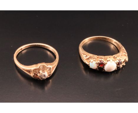 An opal and garnet finger ring (a/f), together with a cluster ring centred by a small diamond, each in 9 ct gold, 4.8 g