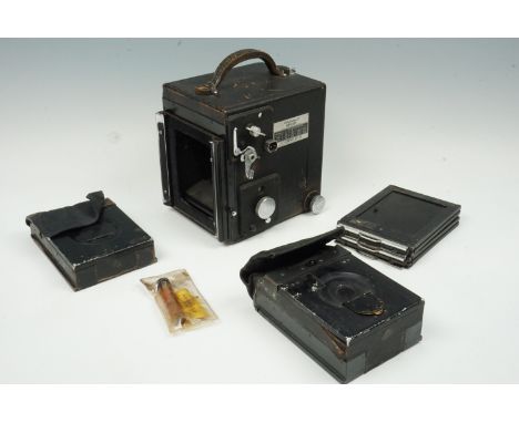 A cased Graflex Super D reflex camera together with two film magazines and a quantity of plate carriers