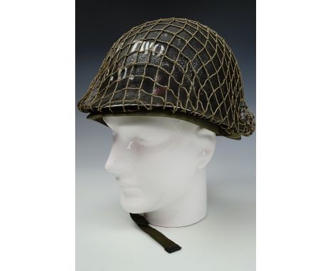 A post-War US army steel helmet