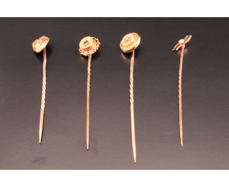 A Victorian 15 ct yellow metal stick pin, its terminal in the form of a heart and set with a small diamond, together with thr