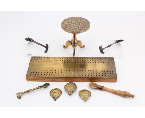 A brass-mounted oak cribbage board, a miniature brass tripod chess table, pastry jiggers and Carlisle brass horse tack mounts