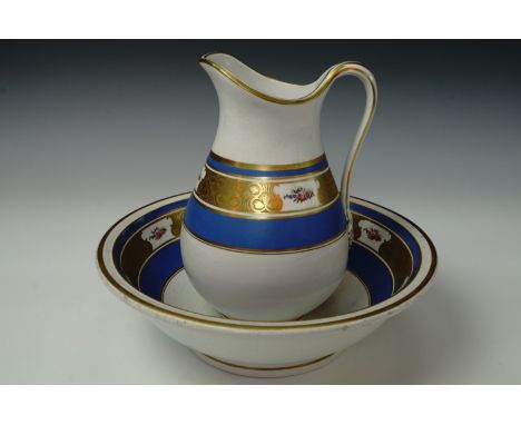 A 19th century child's bedroom room wash basin and jug, having a white body with blue and gilt bands, the gilt bands having w