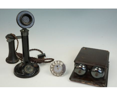 A 1920s black Japanned metal and Vulcanite candlestick telephone, a walnut telephone bell box with twin exposed bells, and a 