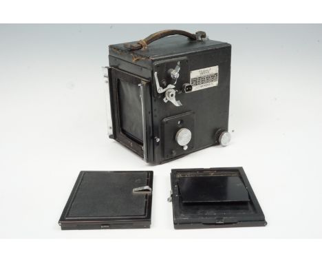 A Graflex Super D reflex camera together with two plate carriers