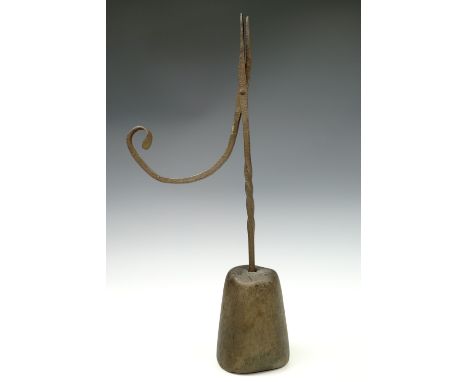 A 19th century wrought iron rush light or rush nip with an wooden base, 38 cm high