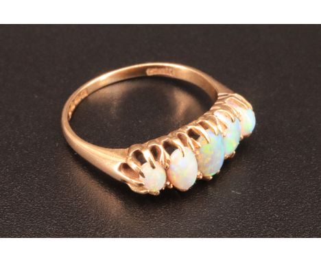 An opal and 18 ct gold ring, line set with five graduated oval opals, London, 1972, 4.1 g