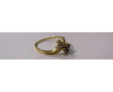 A gold ring with ruby trefoil and diamond trefoil set in a twist, 18ct gold. Size M, 2.2g   