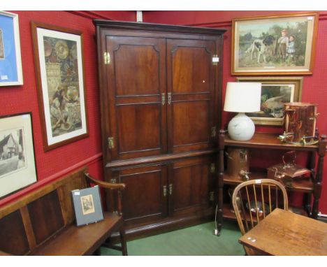 A Georgian oak four door corner cupboard with shaped shelf interior to top, 206cm tall x 130cm wide