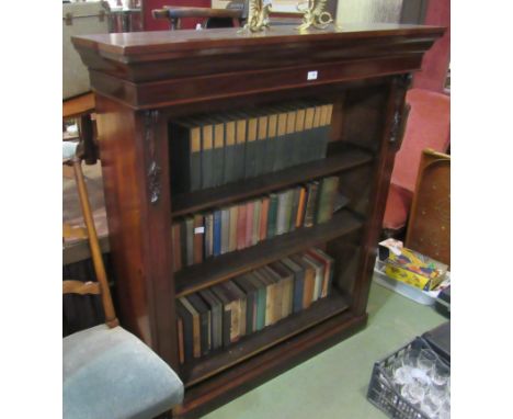 A circa 1860 mahogany bookshelf with carved foliate acanthus leaf corbel decoration and height adjustable shelves over a plin