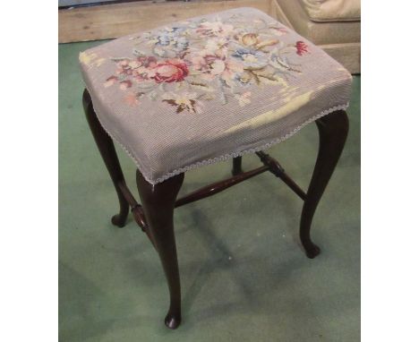 A 19th Century serpentine stool with tapestry upholstery