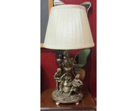 A figural table lamp with shade