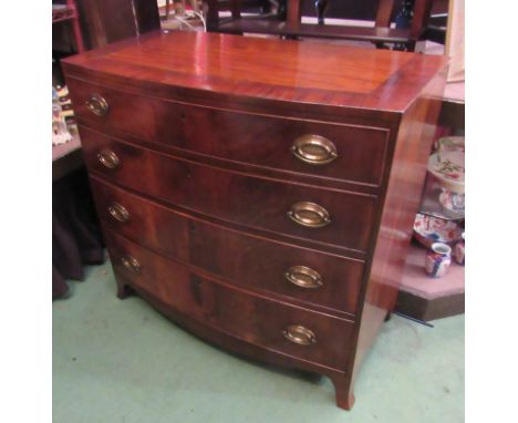 An early Victorian crossbanded mahogany bow front chest of four graduating long drawers with brass oval plate handles on outs