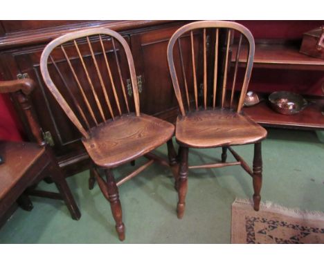 A pair of late 19th Century stick back elm seated chairs with sunken seats, 85cm tall x 39cm wide