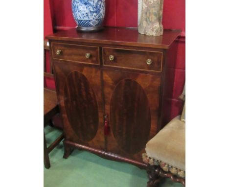 A George III style mahogany side cabinet the two frieze drawers over a two door cupboard with key on outswept bracket feet, 7