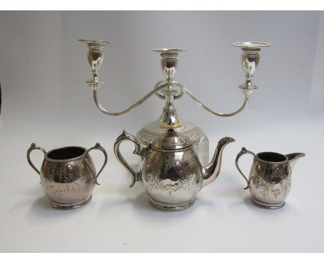 A silver plate three piece tea set and candlestick