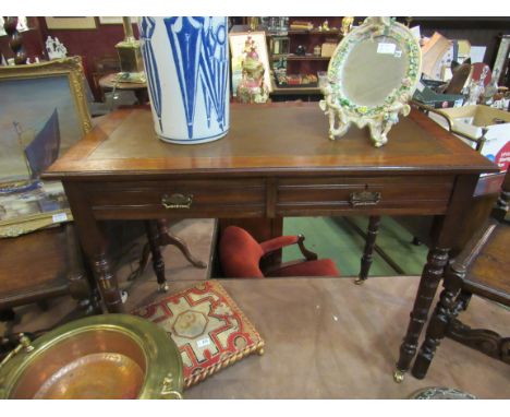 Circa 1900 a walnut writing desk with two frieze drawers on ring turned tapering legs and brass castors, 92cm wide x 50cm dee
