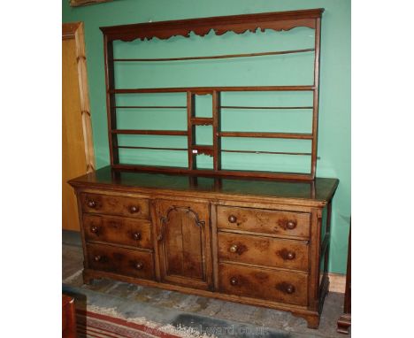 A superb substantial Georgian Oak Dresser Base with delicate plate rack, the rack having moulded cornice over intricate fret-