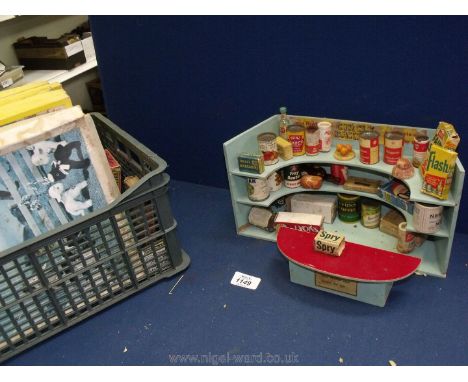 An old children's Toy Shop with shelf and counter, tins and packets together with wooden jigsaws, Cow and Gate playing cards 