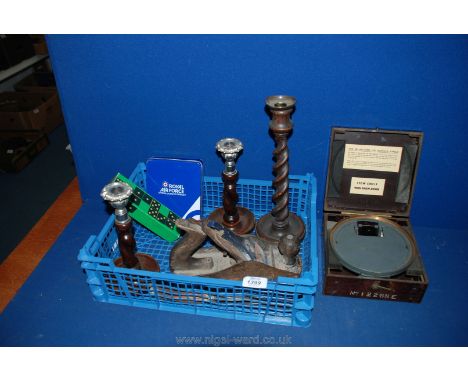 A box of miscellanea including large wooden candlestick, pair of wooden and silver plated candlesticks, wooden plane, carving