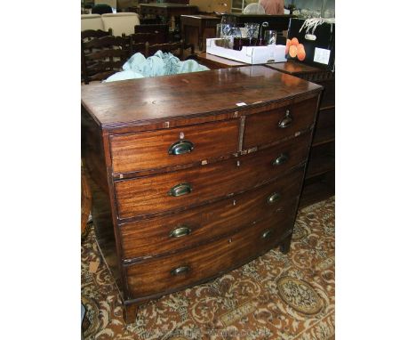 An early 19th c. bow fronted Mahogany Chest of two short over three long graduated drawers, the plain top having reeded edges