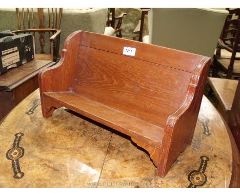A Bookshelf in the form of a wooden bench.
