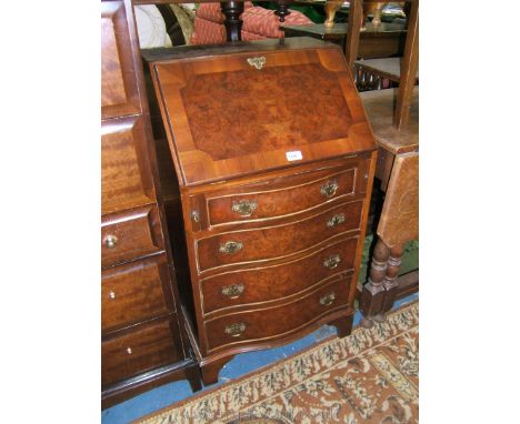 A reproduction Walnut finished Queen Anne style Bureau, the cross-banded burr top over a similar fall opening to reveal six p