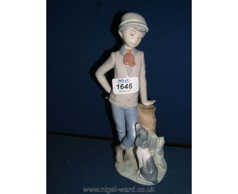 A Nao figurine of a young boy with a faithful puppy at his feet