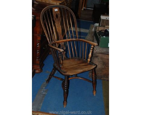 An early 19th c. mixed wood crinoline Windsor Chair, the top hoop of bent Ash, the arm hoop of bent Beech, Oak splat, fret-cu