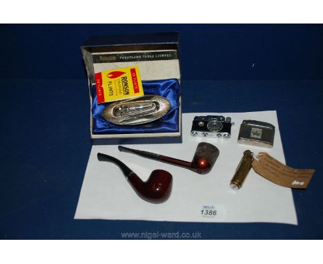 Various Lighters including one in the form of a camera, a brass trench lighter and two Pipes