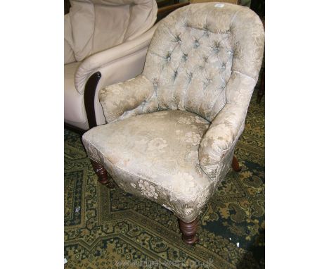 An elegant 19th c. Tub Chair, having hooped button back with low padded arms, serpentine shaped seat, standing on turned legs