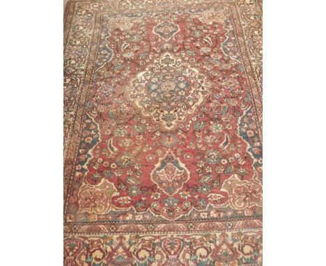 A vintage hand knotted Turkish Rug with central medallion with floral borders, 58'' x 78''.